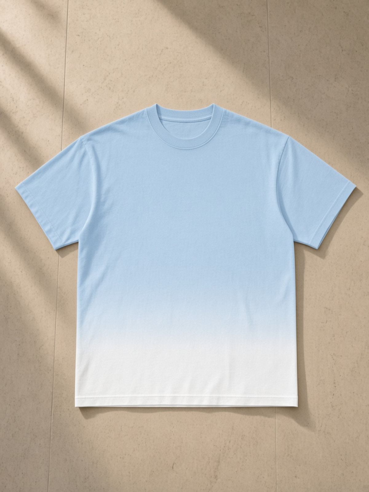 Sunfade Vintage Washed T-Shirt in Blue, laid flat on pale limestone, front.