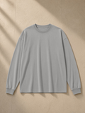 Vintage Washed Long Sleeve T-Shirt in Medium Gray, laid flat on pale limestone