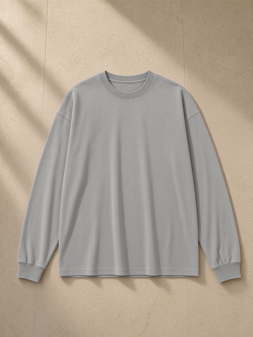 Vintage Washed Long Sleeve T-Shirt in Medium Gray, laid flat on pale limestone