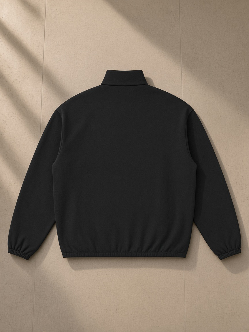 Heavyweight Stand Collar Jacket in Black, laid flat on pale limestone, back view