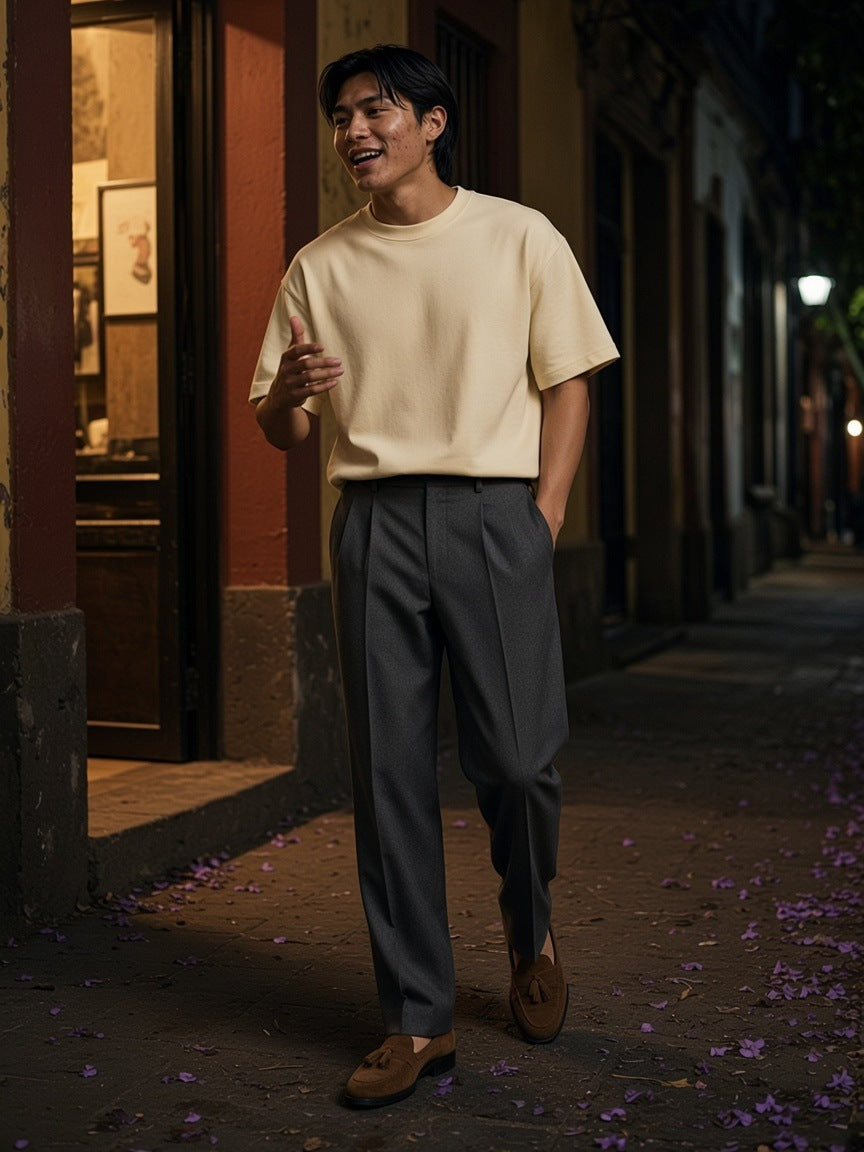 Man in the Classic Loose Boxy Tee in Apricot on a jacaranda street in Colonia Roma, Mexico City at night