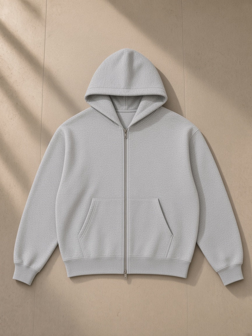 Contrast-stitched boxy fleece zip hoodie in Flower Gray, laid flat on pale limestone, front view