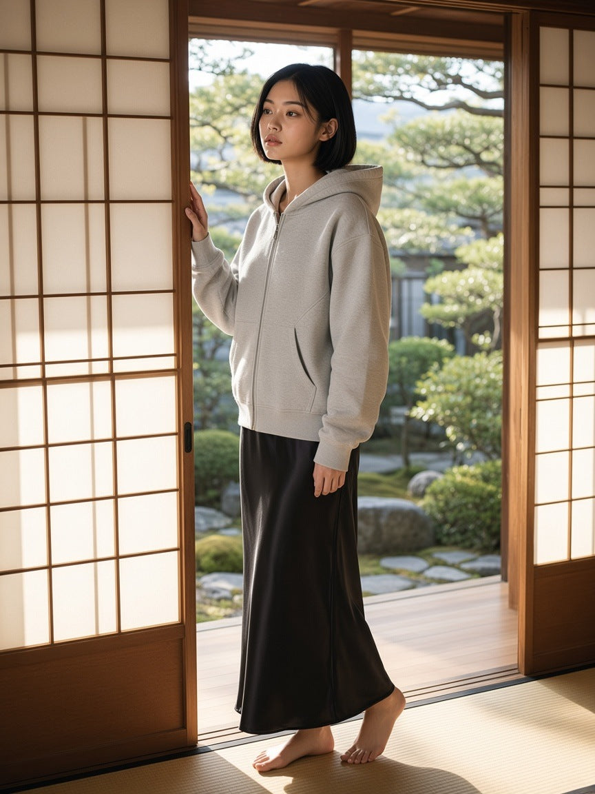 Woman in the Contrast-Stitched Boxy Fleece Zip Hoodie in Flower Gray kneeling in a ryokan room in Kyoto by day