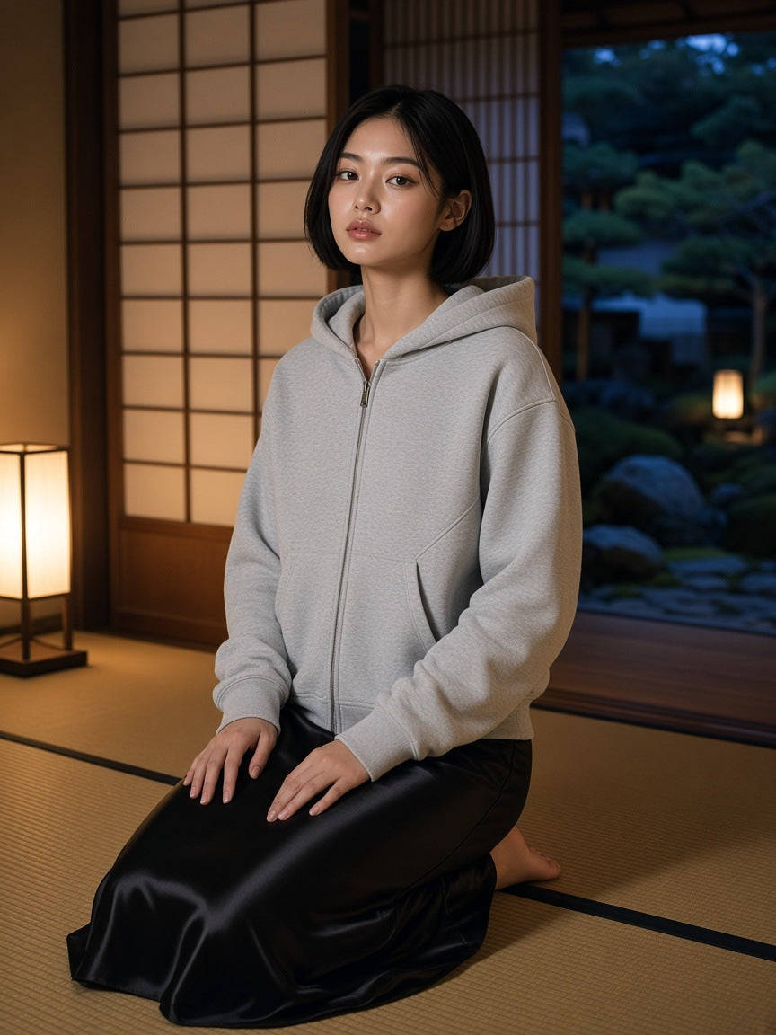 Woman in the Contrast-Stitched Boxy Fleece Zip Hoodie in Flower Gray kneeling in a ryokan room in Kyoto at night