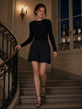 Woman in Cotton Shorts in Black coming down a Paris apartment staircase at night