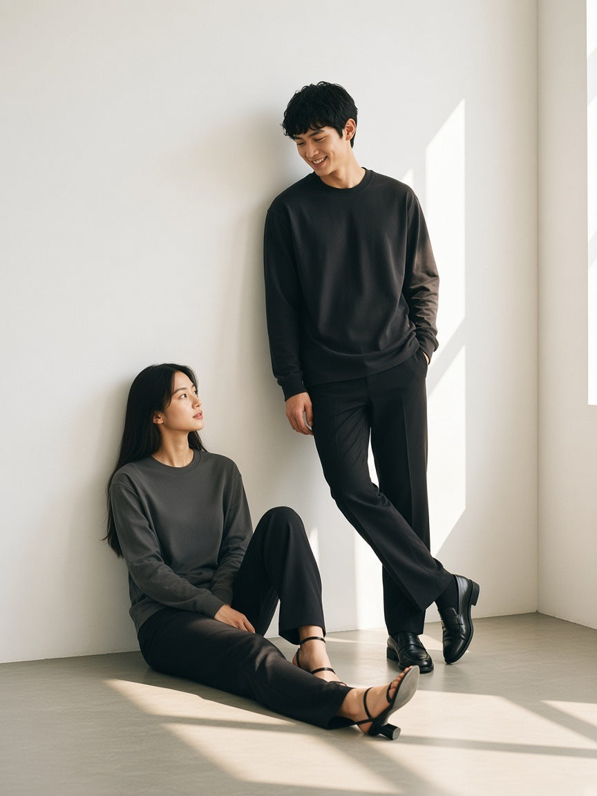 Two people in the Crew Neck Drop Shoulder Long Sleeve Shirt in Black and Dark Gray in a white plaster room by day
