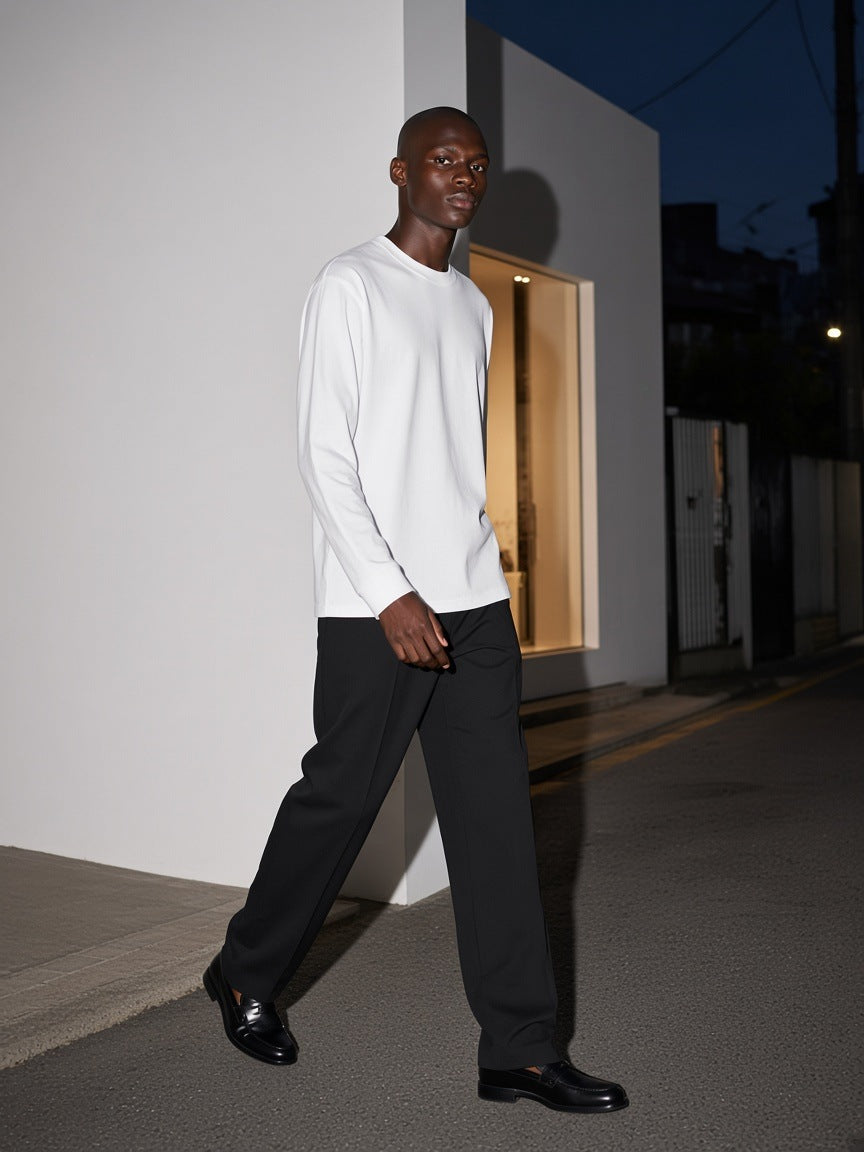Man in the Crew Neck Drop Shoulder Long Sleeve Shirt in Basic White walking a gallery street in Seoul at night