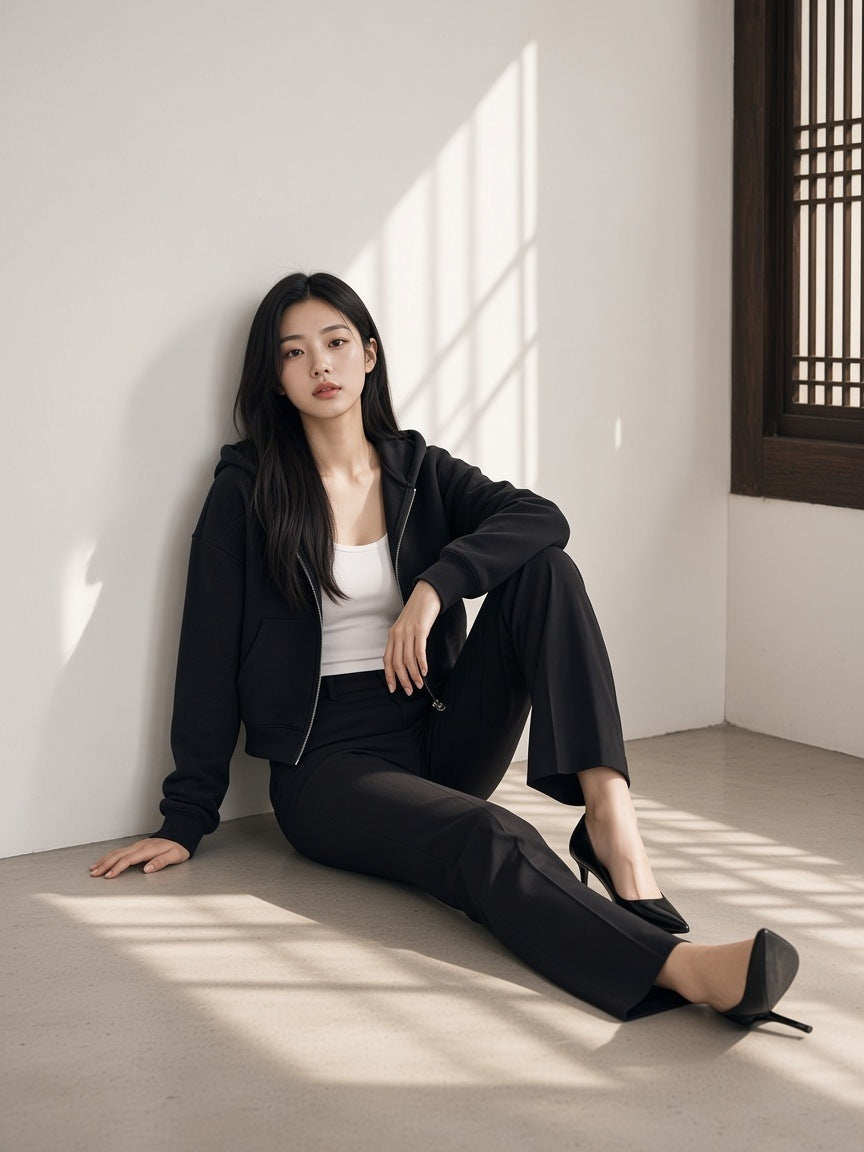 Woman in the Cropped Zip-Through Hoodie in Black in an empty gallery in Seoul by day