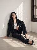 Woman in the Cropped Zip-Through Hoodie in Black in an empty gallery in Seoul by day
