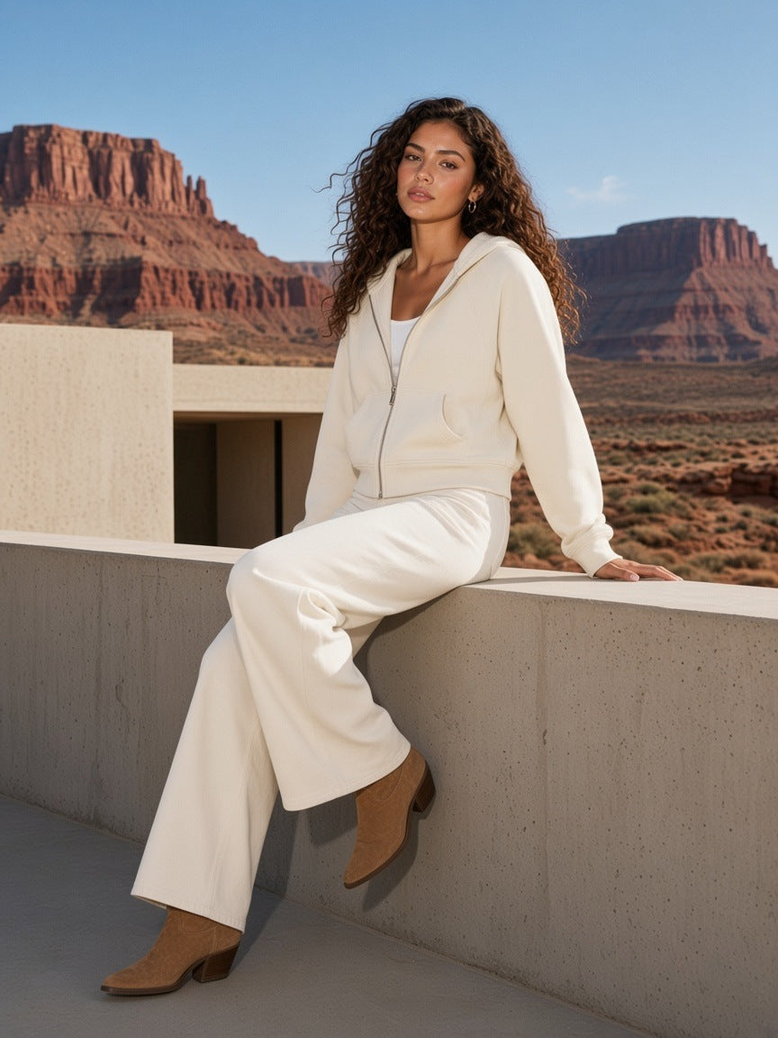 Woman in the Cropped Zip-Through Hoodie in Mild Apricot walking a desert resort courtyard in Utah by day