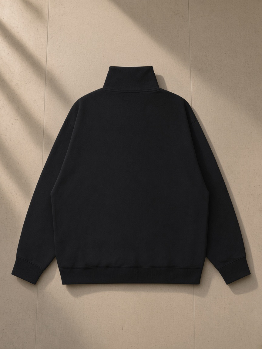 Quarter-Zip Drop Shoulder Sweatshirt in Black, laid flat on pale limestone, back view