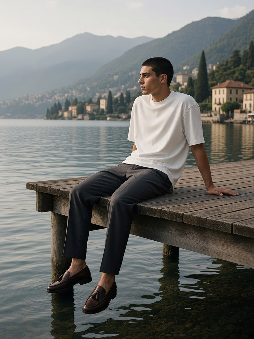 Man in the Oversized Cotton T-Shirt in White on a villa dock on Lake Como in the morning
