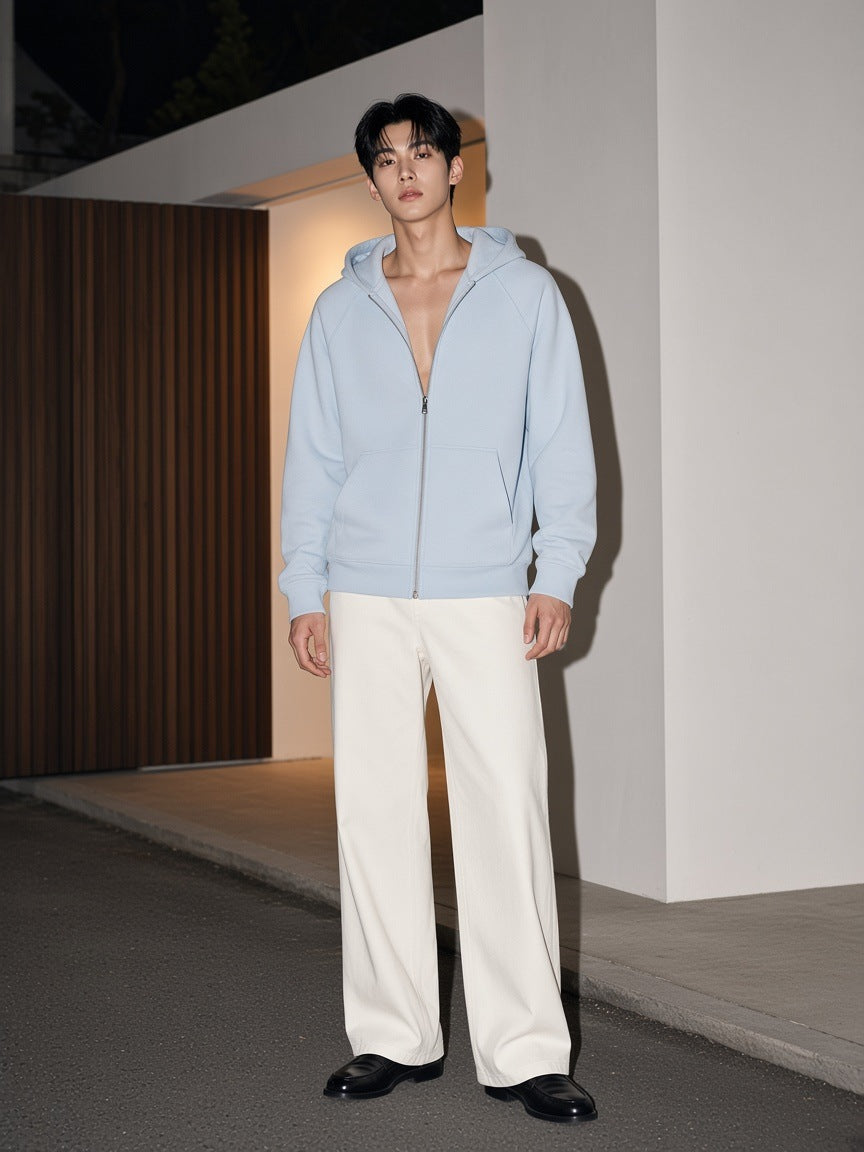 Man in the Marcel Afters Raglan Full Zip Hoodie in Light Blue on a gallery street in Seoul at night