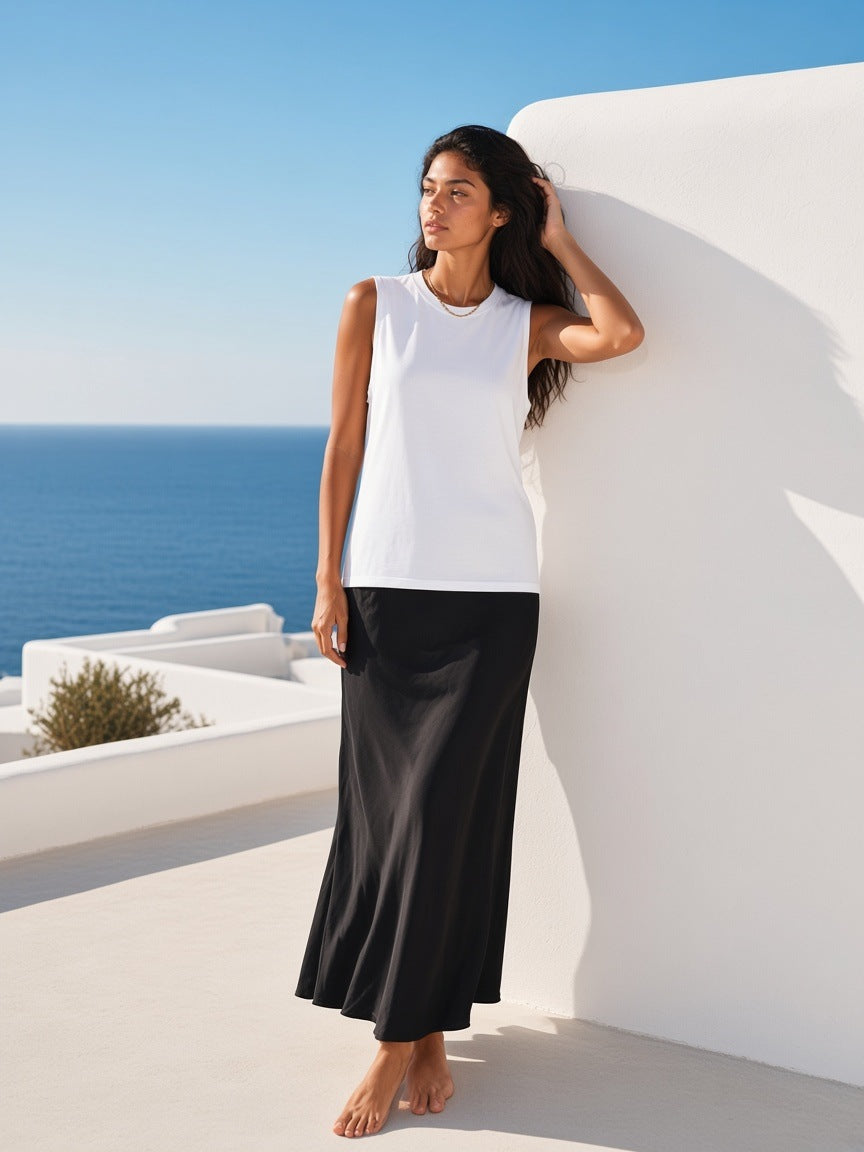 Woman in the Raw Edge Cotton Tank Top in White on a whitewashed hotel terrace on Mykonos by day
