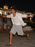 Man in the Raw Edge Fleece Shorts in Flower Gray, sprinting along the Mykonos harbour at 1am