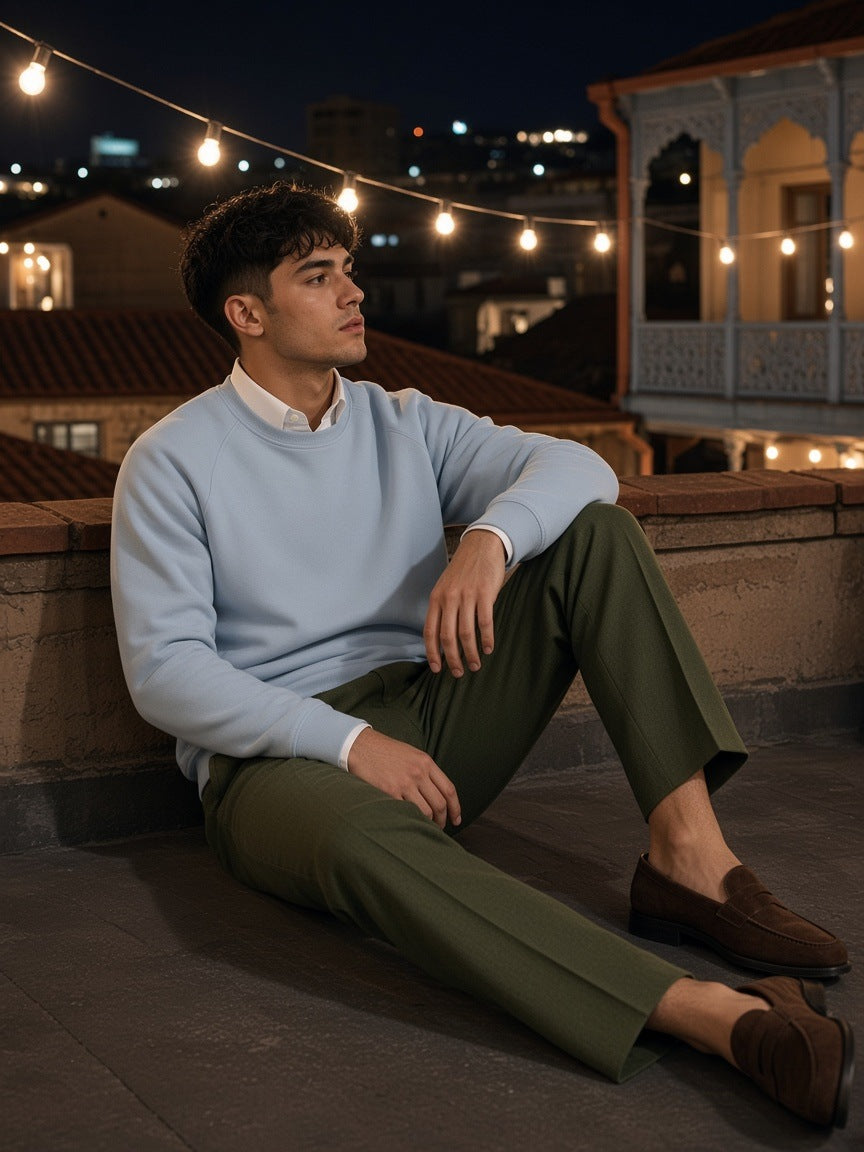 Woman in the Marcel Afters Regular Fit Crewneck Sweatshirt in Light Blue in an adobe courtyard in Marfa, Texas at night