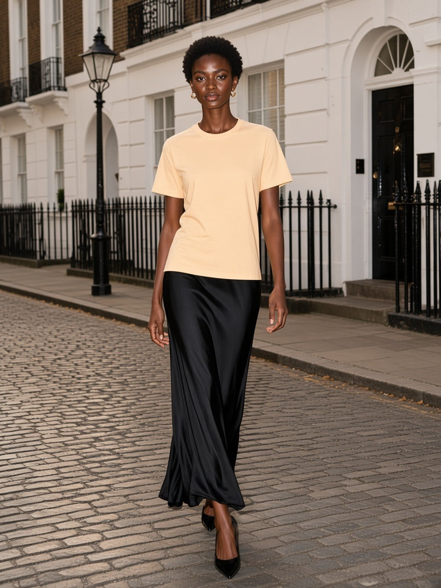 Woman in the Seamless Cotton T-Shirt in Apricot walking a Mayfair mews in London in the morning