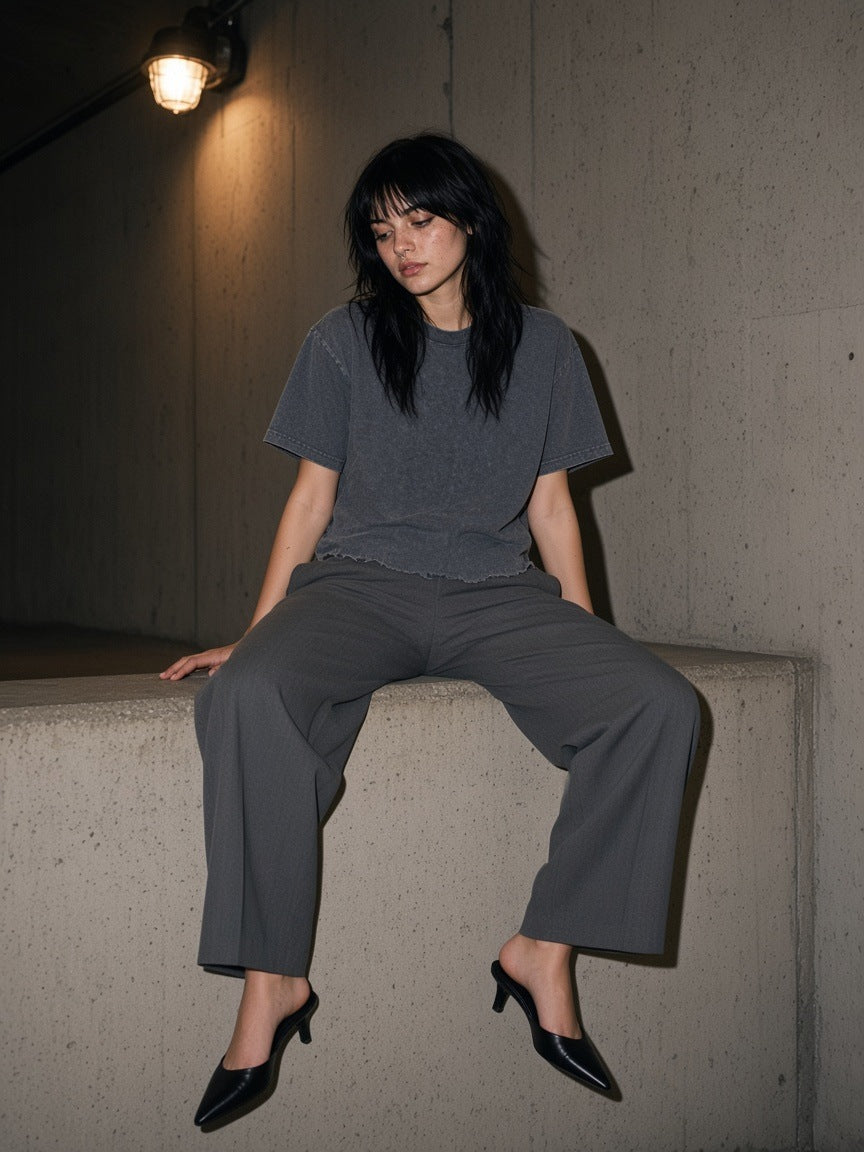 Woman in the Marcel Afters Snow Wash Raw-Hem Boxy T-shirt in Washed Cement Gray on the porch of a ranch lodge in Montana at dusk