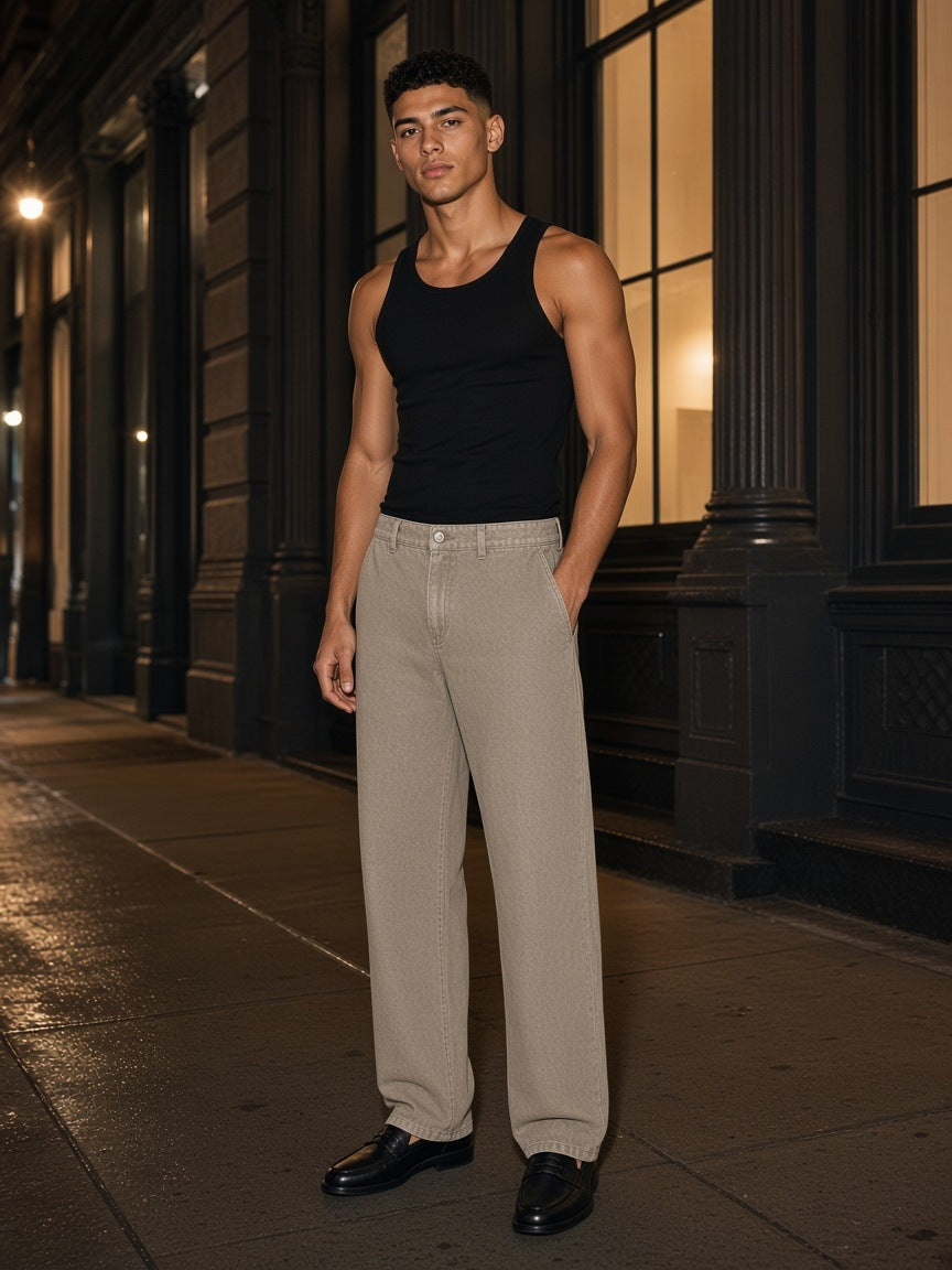 Man in the Marcel Afters Snow Washed Straight Leg Pants in Stone Gray on a SoHo street in New York at night