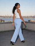 Woman in the Straight Leg Sweatpants in Sky Blue on a rooftop over the Hudson in New York by day