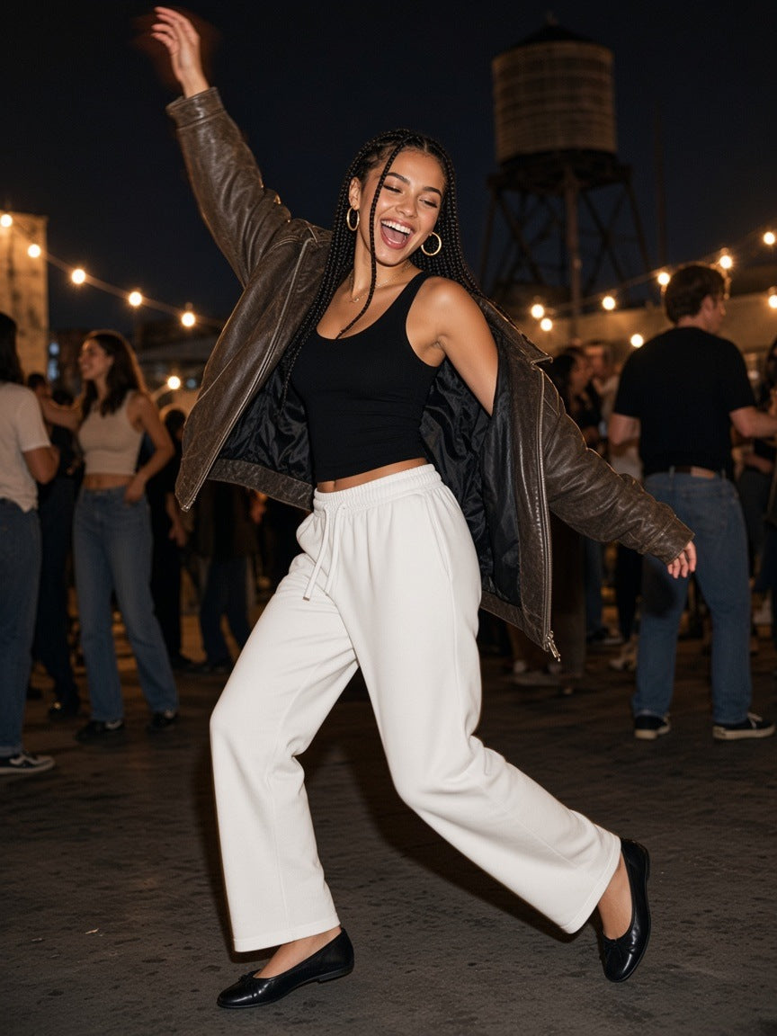 Woman in the Marcel Afters Straight Leg Sweatpants in Sky Blue on a rooftop over the Hudson in New York at night