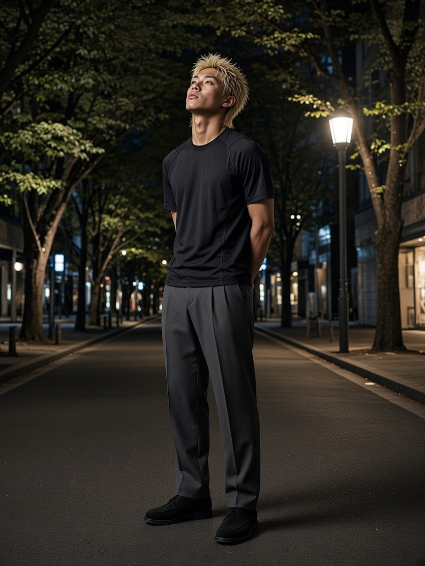 Man in the Tonal Paneled Performance T-Shirt in Black on the Omotesando avenue in Tokyo at night