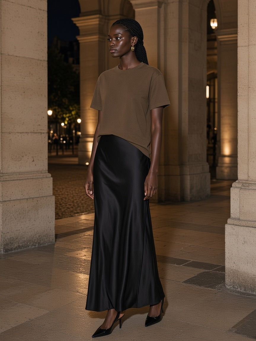 Woman in the Vintage Wash Distressed T-Shirt in Coffee, under a stone colonnade at night in Paris