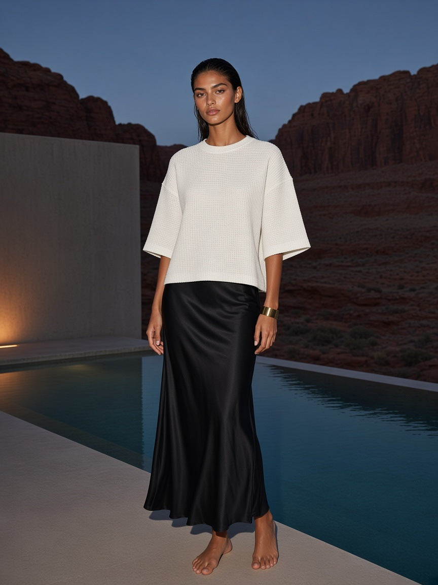 Woman in the Marcel Afters Waffle Boxy T-Shirt in White at a desert resort pool in Utah at blue hour