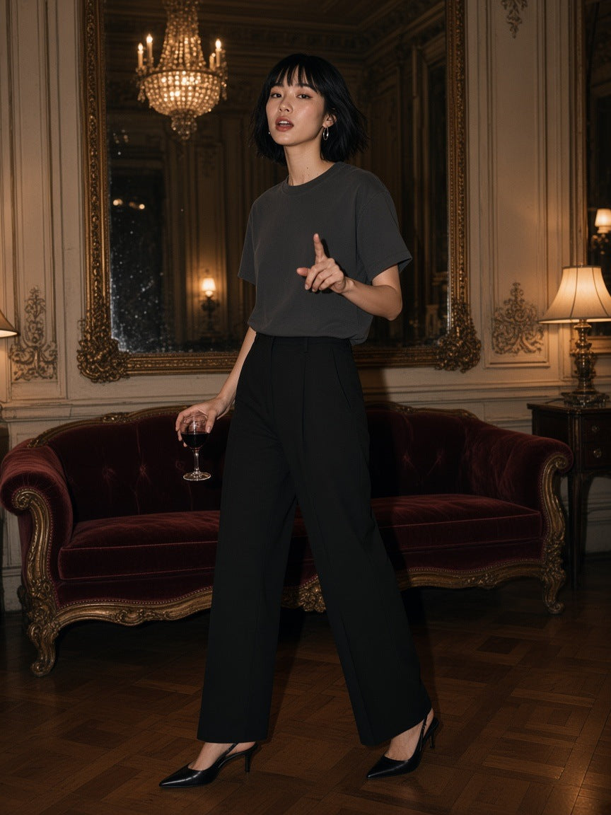Woman in the Marcel Afters Washed Rolled Hem Half Sleeve T-Shirt in Dark Gray, in a Belle Epoque hotel salon at night in Buenos Aires