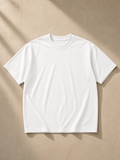 Unisex loose drop shoulder t-shirt in White, laid flat on pale limestone