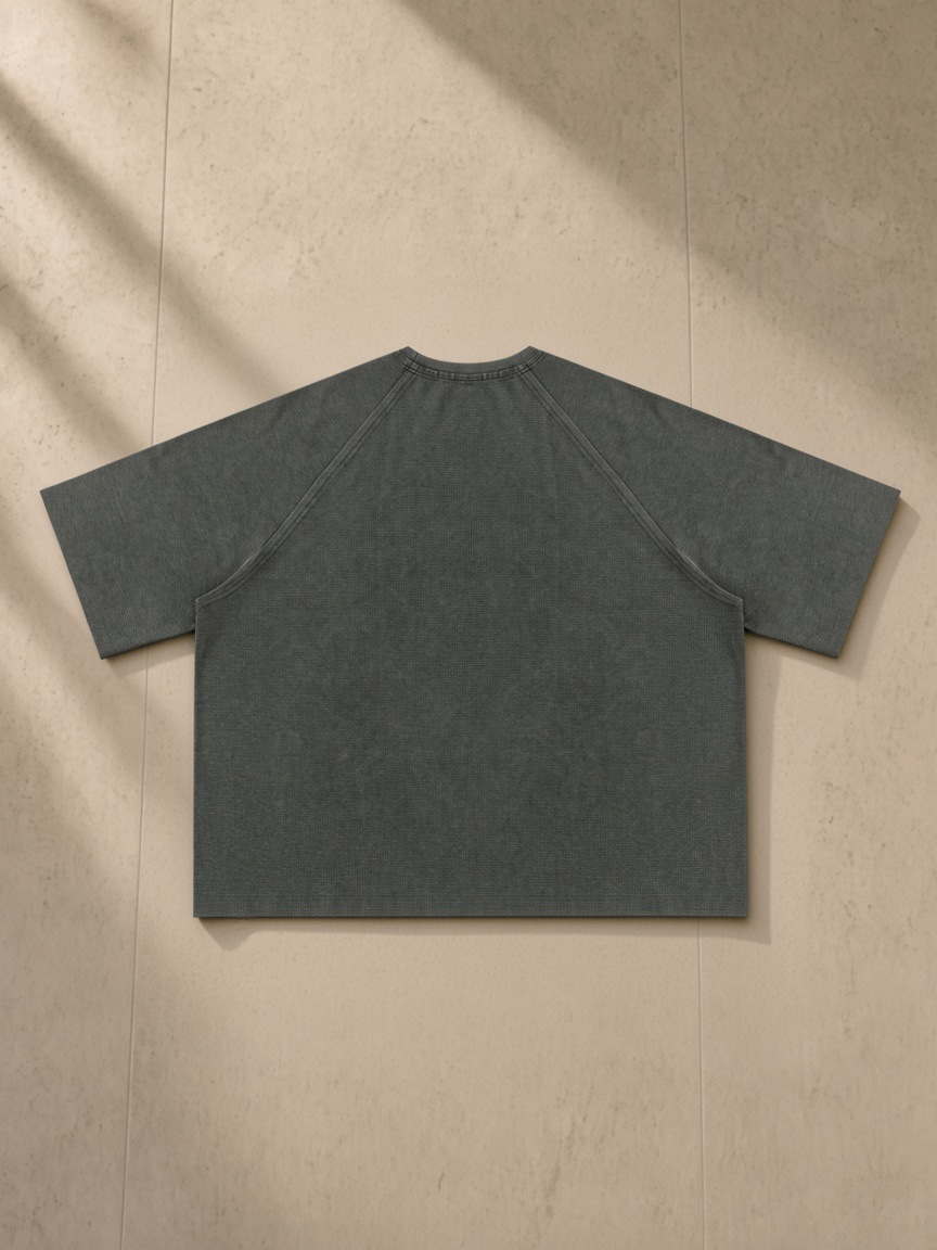 Mineral Wash Boxy Waffle T-Shirt in Gray, laid flat on pale limestone, back.