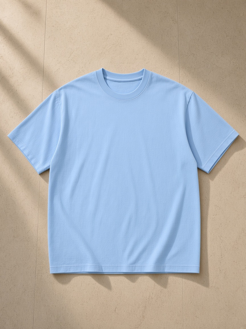 Unisex cotton t-shirt in Blue, laid flat on pale limestone