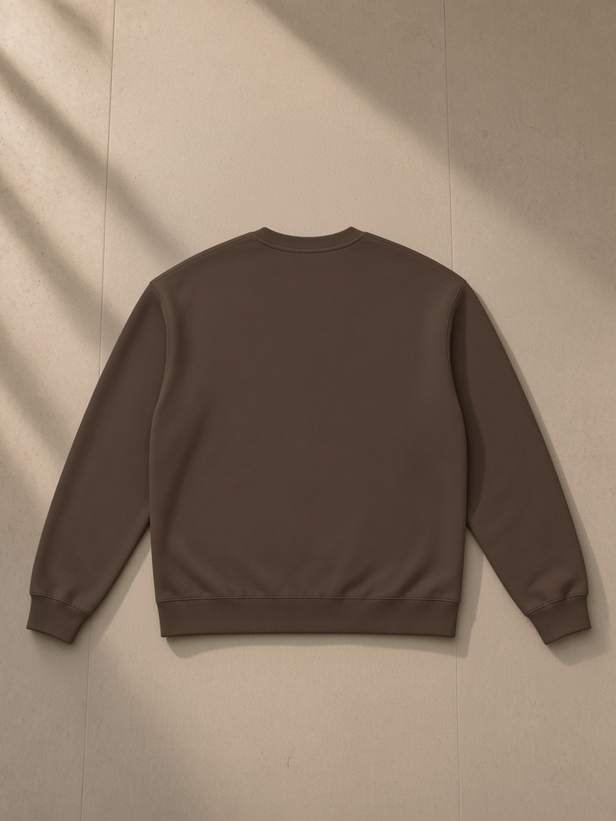 Heavyweight Crewneck Sweatshirt in Coffee, laid flat on pale limestone, back view