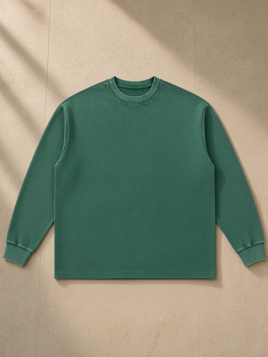 Mineral wash waffle oversized t-shirt in Blackish Green, laid flat on pale limestone