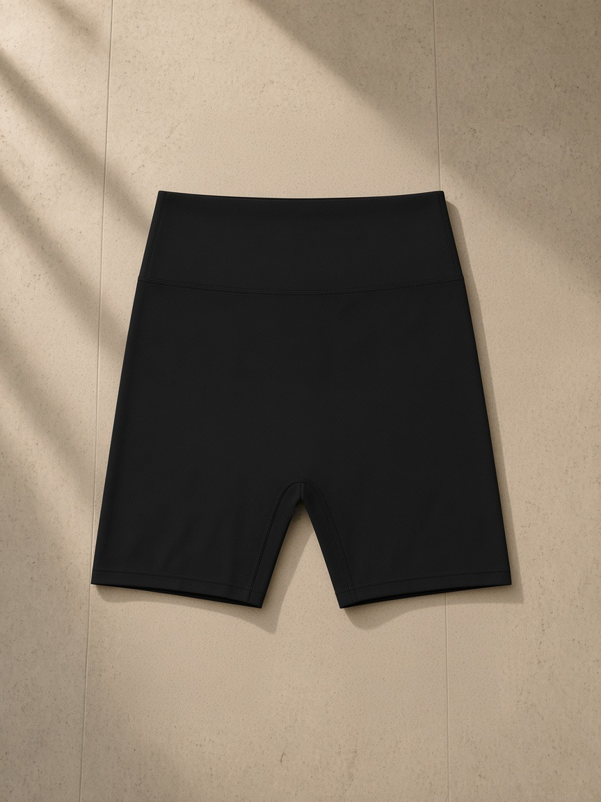High-Waisted Blend Biker Shorts in Black, laid flat on pale limestone