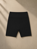 High-Waisted Blend Biker Shorts in Black, laid flat on pale limestone
