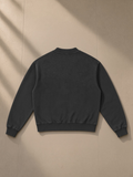 Unisex vintage wash fleece quarter zip sweatshirt in Black, laid flat on pale limestone, back view