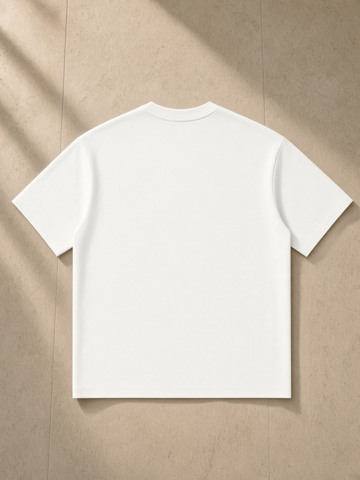 Oversized Piping Henley T-Shirt in White, laid flat on pale limestone, back.