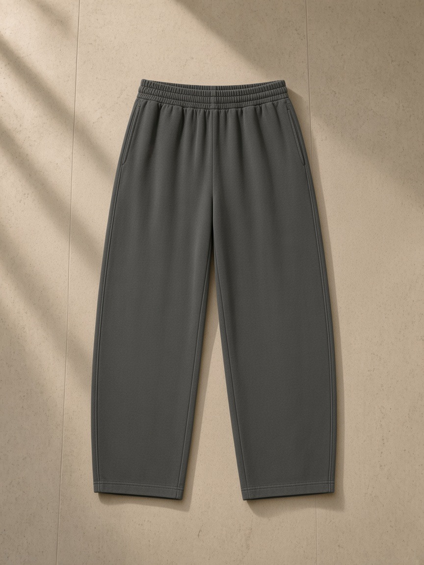 Vintage washed barrel leg sweatpants in Dark Gray, laid flat on pale limestone