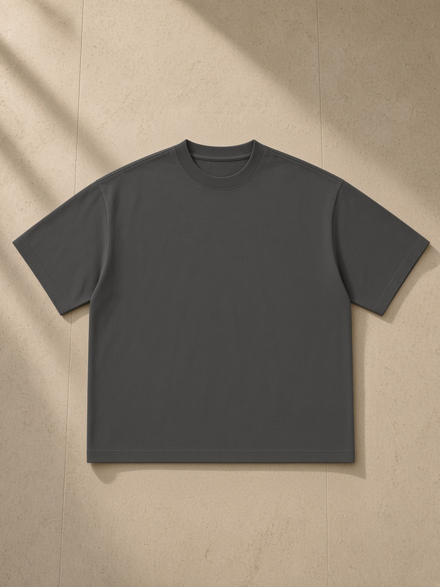 Women's Boxy Oversized T-Shirt in Dark Gray, laid flat on pale limestone