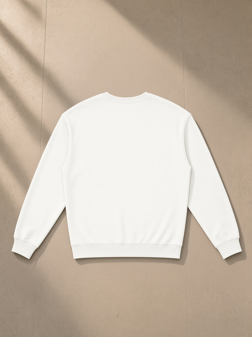 Loose Crewneck Sweatshirt in White, laid flat on pale limestone, back view