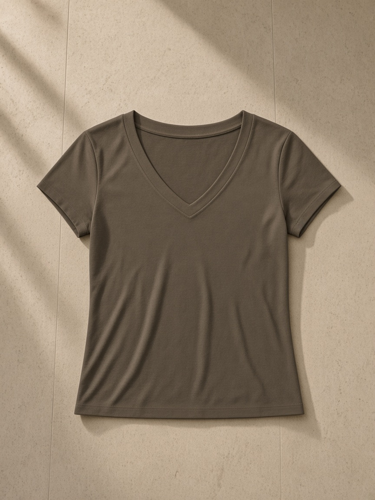Tencel Slim Fit V-Neck T-Shirt in Brown, laid flat on pale limestone, front.