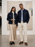 Two people in the Vintage Wash Denim Jacket in Navy Blue at a gallery opening