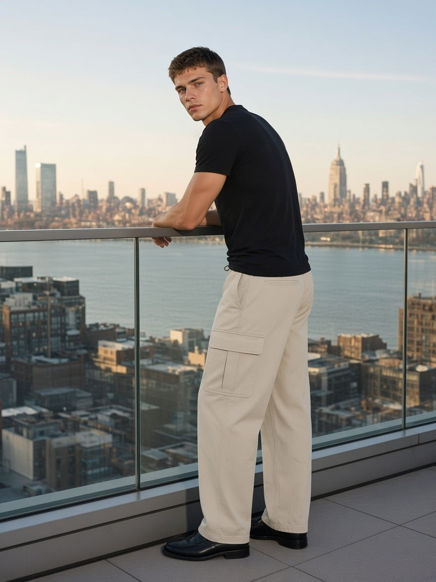 Man in the Drawstring Waist Straight-Leg Cargo Pants in Light Gray on a rooftop over the Hudson in New York by day