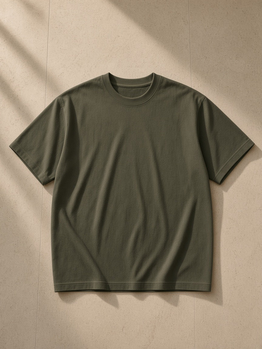 Drop Shoulder Cotton T-Shirt in Army Green, laid flat on pale limestone