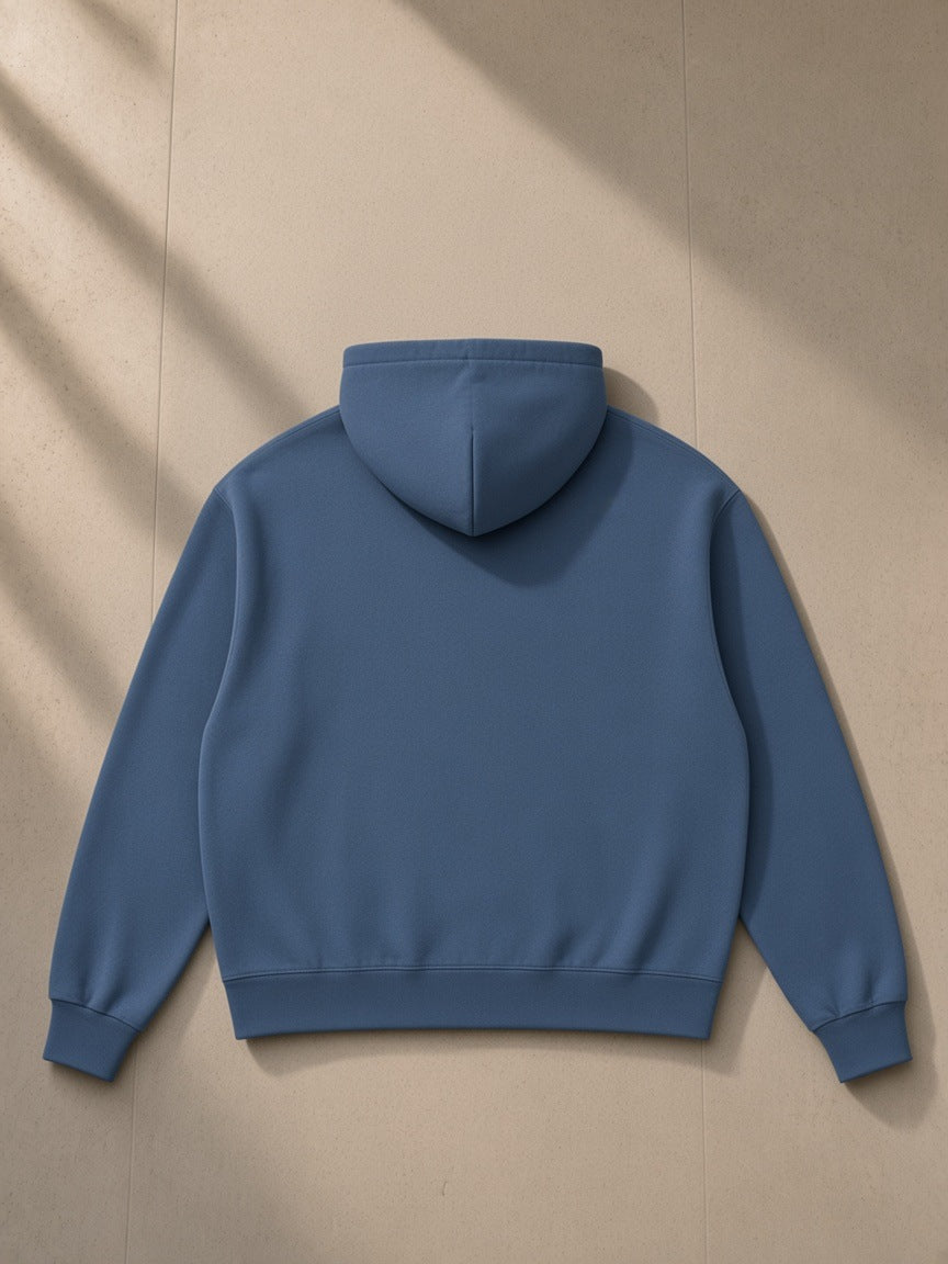 Drop Shoulder Full Zip Hoodie in Haze Blue, laid flat on pale limestone, back view
