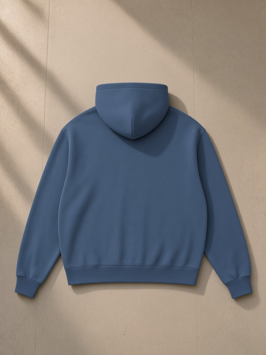 Women's Drop Shoulder Full Zip Hoodie in Haze Blue, laid flat on pale limestone, back view