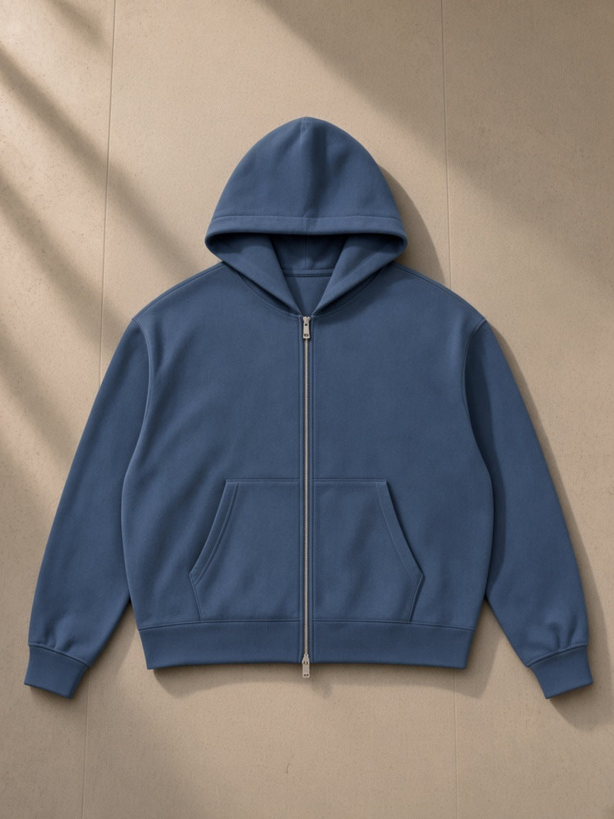 Women's Drop Shoulder Full Zip Hoodie in Haze Blue, laid flat on pale limestone