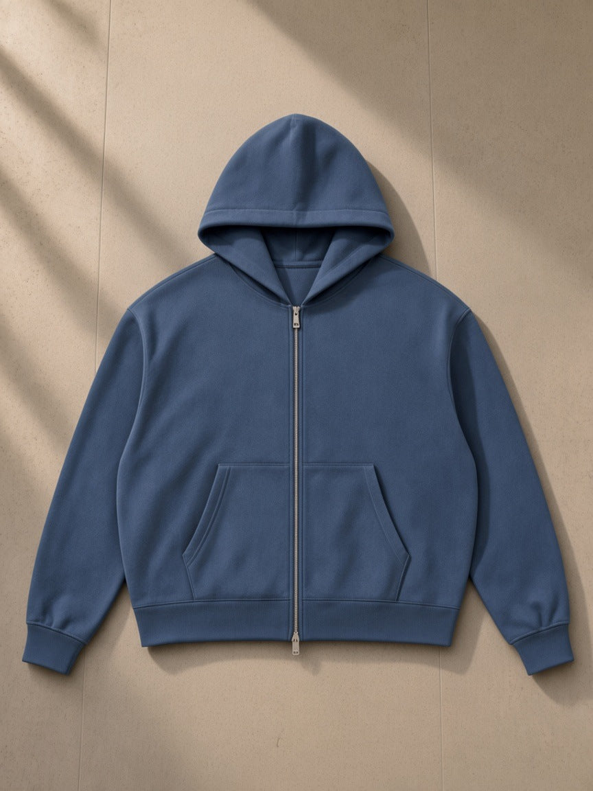 Women's Drop Shoulder Full Zip Hoodie in Haze Blue, laid flat on pale limestone