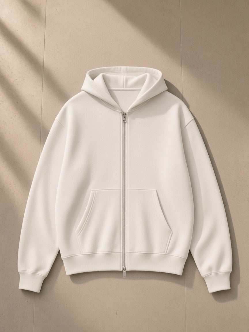 Women's Drop Shoulder Full Zip Hoodie in White, laid flat on pale limestone